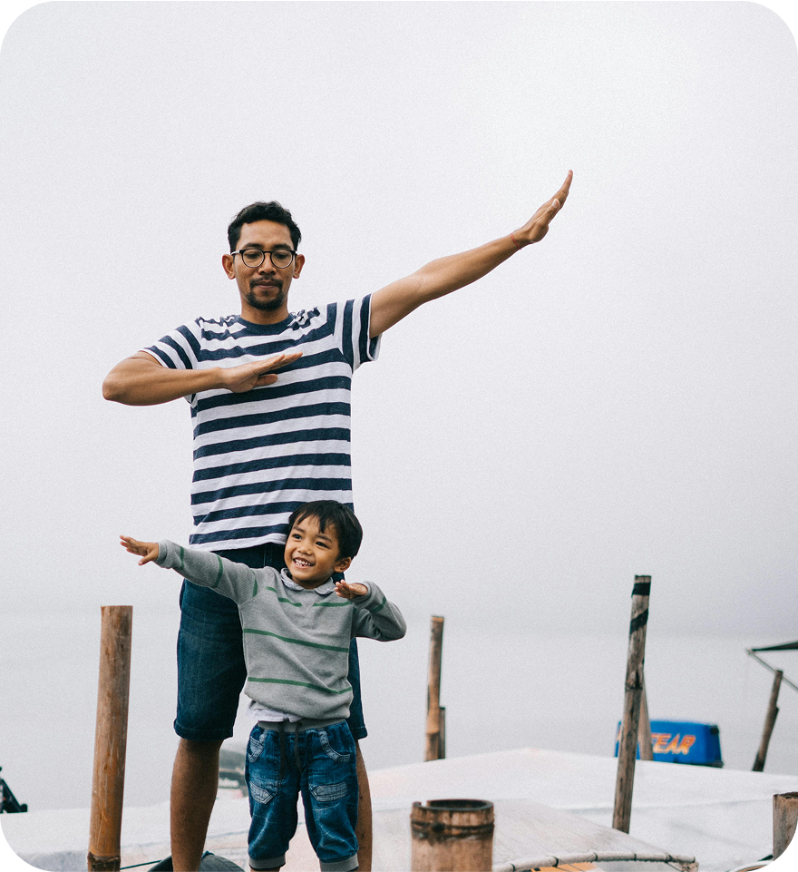 Father and son strike a pose on the pier